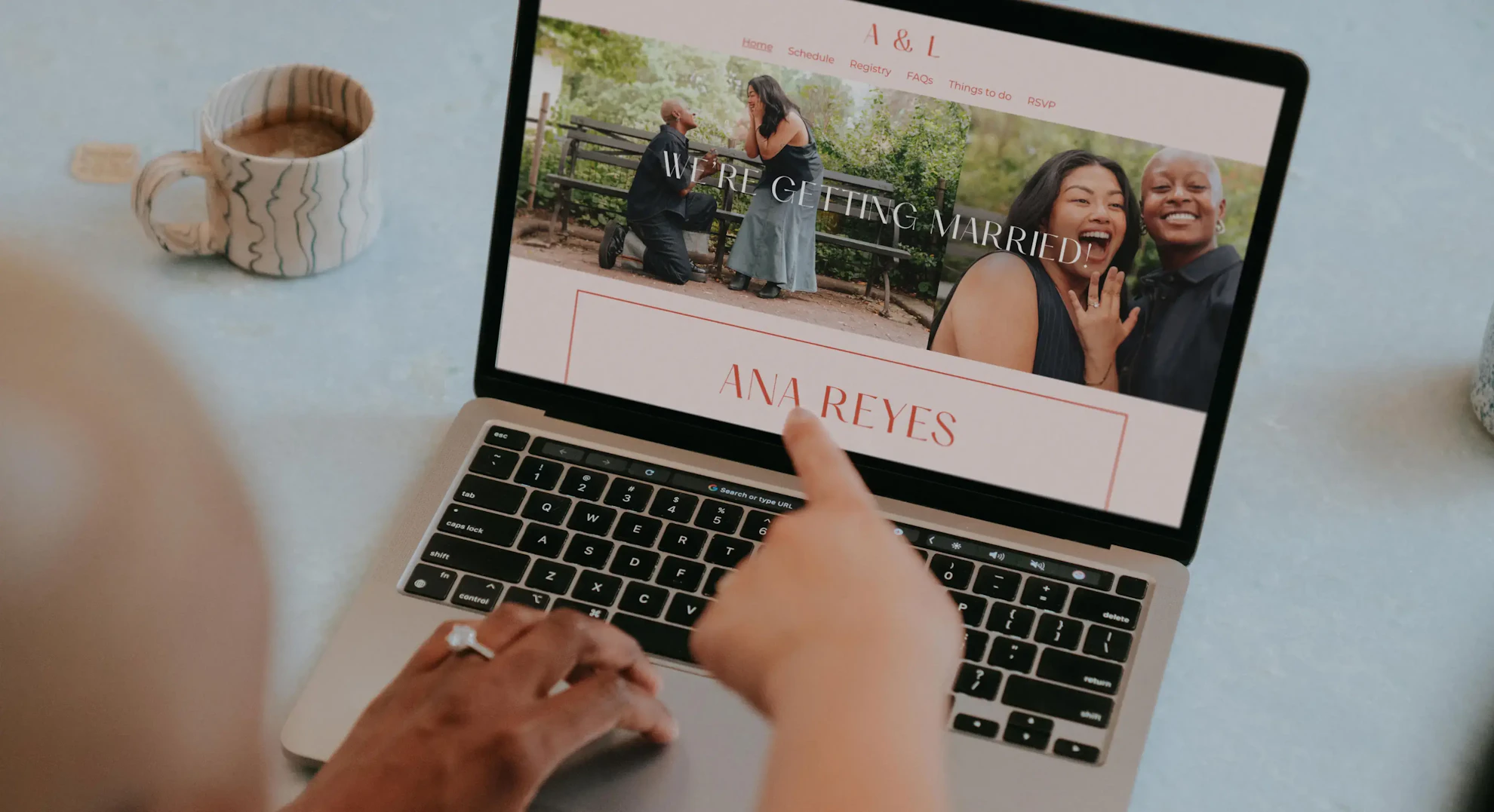 Laptop open to a Zola wedding website