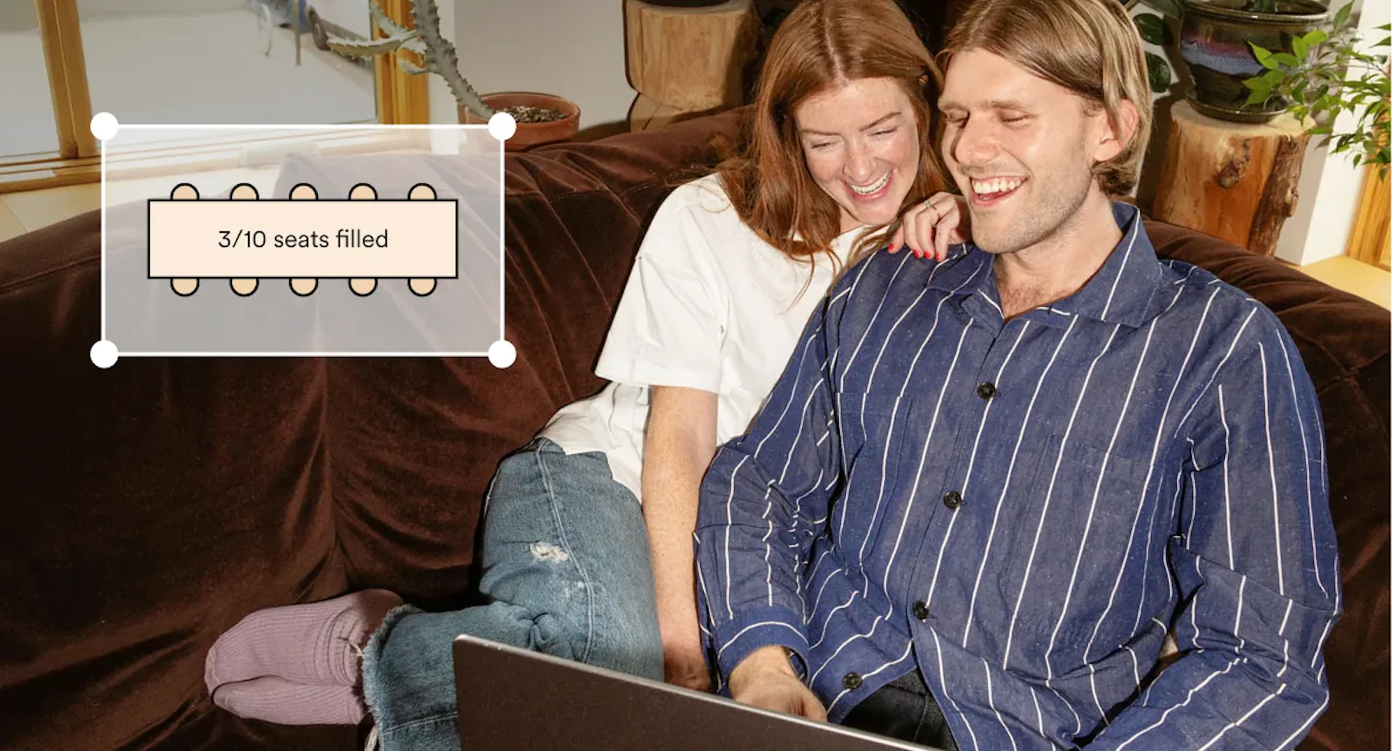 Couple laughing on a couch while looking at a laptop, with an overlay showing a seating chart table with 3 of 10 seats filled